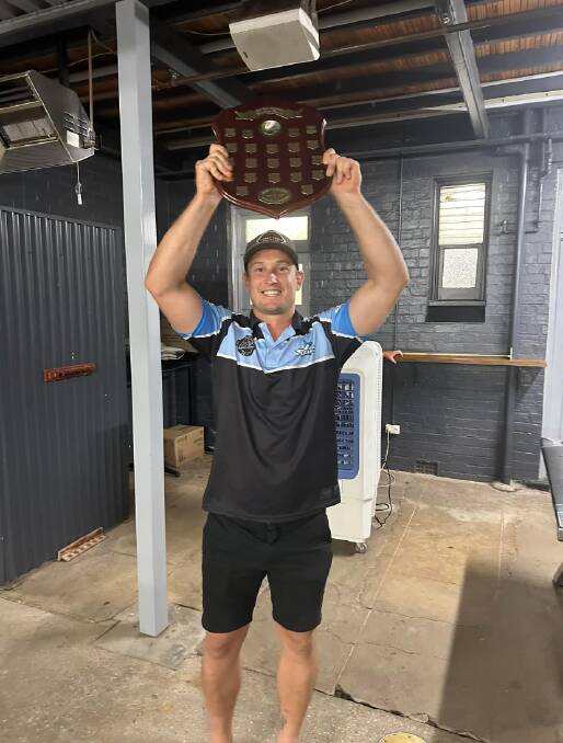 New captain coach Dean Scott holds up the Ack Weyman shield. Photo supplied.