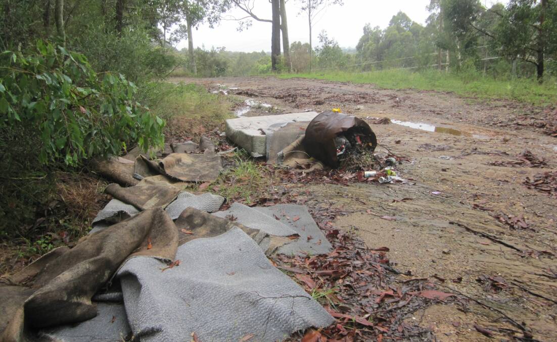 A reader has sent this picture of rubbish on the dirt road that runs past the cemetery and the motor vehicle showrooms on the Princes Highway, south of Batemans Bay.