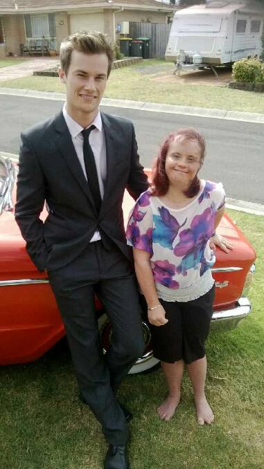 Cody Hutchison, 19, and sister Charnai, 23, of Albion Park. Cody is flooded in, but safe, at Bendethera to the relief of Charnai, who has Down syndrome and their mother, Lee. Ms Hutchison said Cody is the backbone of the family.