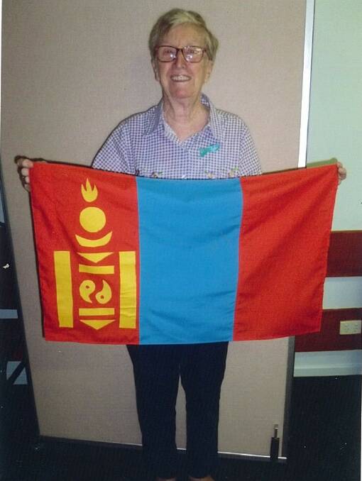 Batemans Bay CWA craft officer Fay Ingram shows off the Mongolian flag. The branch is studying Mongolia.