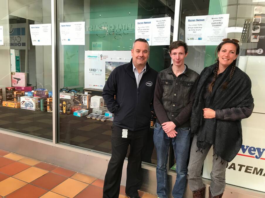 BUY A BALE: Harvey Norman Batemans Bay manager Jason Cooper, Josh Kinchela and Jessica Swift at the pop-up fundraising store for drought stricken farmers.