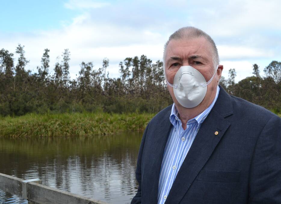 BAT MAN: Russell Schneider has been appointed head of the new flying fox task force. The Broulee resident suffers from emphysema, so wore a mask when he inspected the Batemans Bay Water Garden. 
