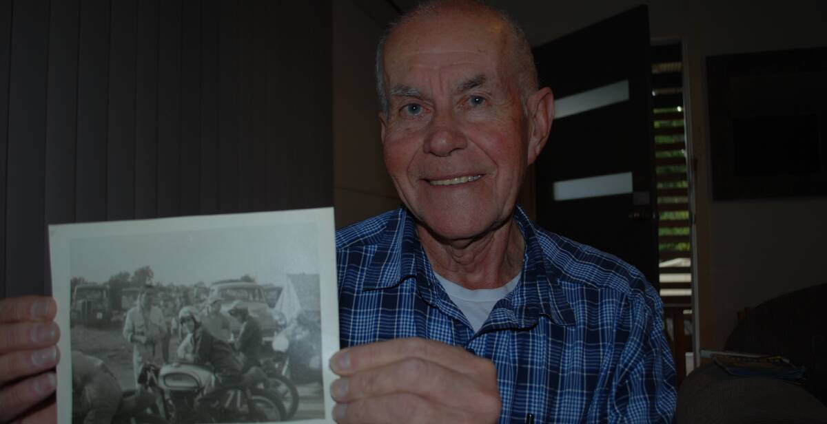 OLD MATES: Batemans Bay's Eric Stallard with a photo of himself and Peter Sharman at a motorbike racing circuit in the 1960s.