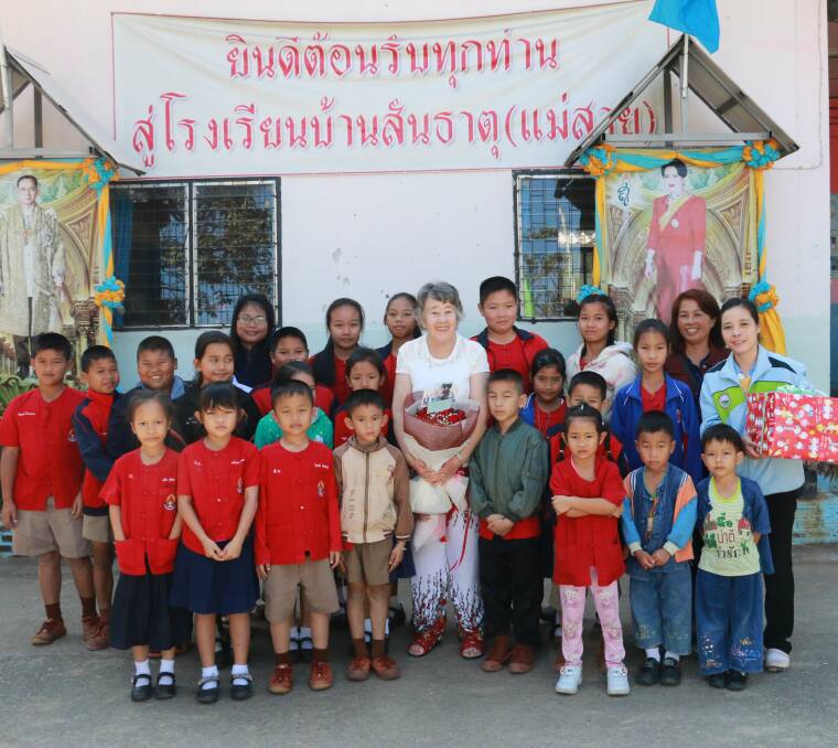 Eileen Thompson (middle in white) with some of the children she taught in Thailand.