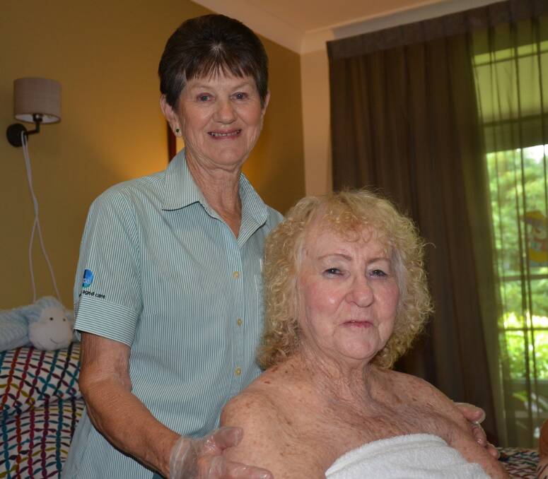 GREATLY VALUED: Registered nuse Margaret Jobson gives an appreciative Opal Denhams Beach resident Lee Edwards a pain management massage. 
