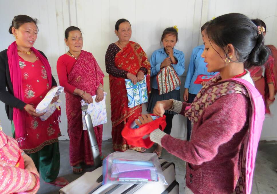 SANITARY KITS: A Nepalese women explaining how the Days For Girls kits work. The kits were made by a Eurobodalla group for the Asha Foundation. 