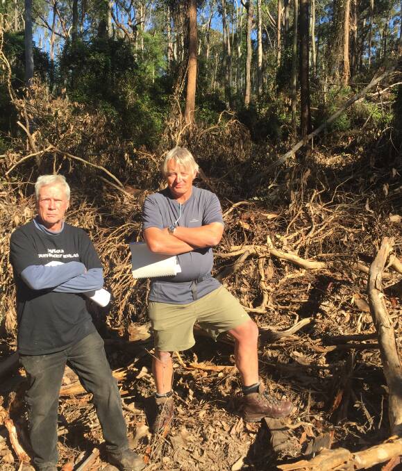 NOT HAPPY: Durras residents Noel Plumb and John Perkins are concerned the logging debris left in the Boyne State Forest is a fire hazard. 