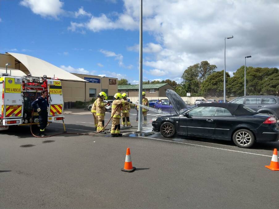 CAR FIRE: Mourya Fire and Rescue crew members douse a car fire at a Moruya shopping centre car park on March 7. Photo: Mourya Fire and Rescue.