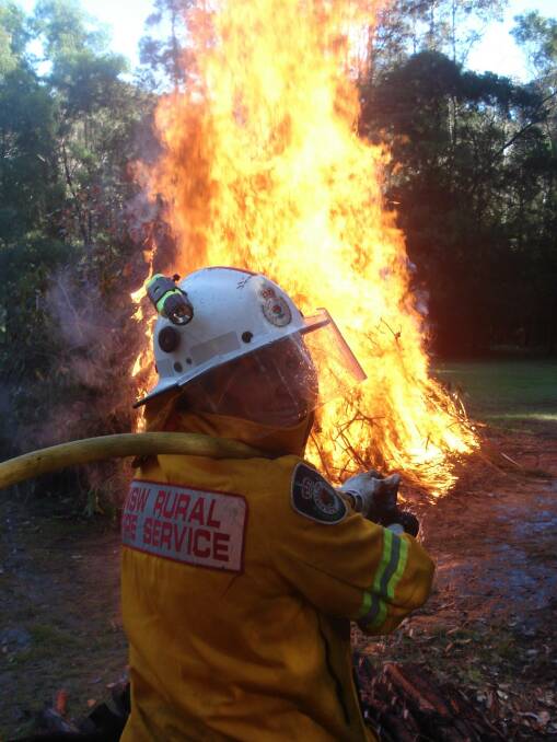 Narooma RFS brigade member Gillian Kearney oversees a pile burn. 