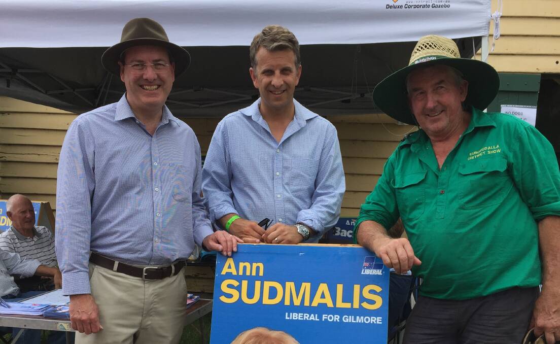 AT THE SHOW: Federal Member Dr Peter Hendy, State Member Andrew Constance and show society president Bruce Reid with now local Federal Member Ann Sudmalis' sign.  