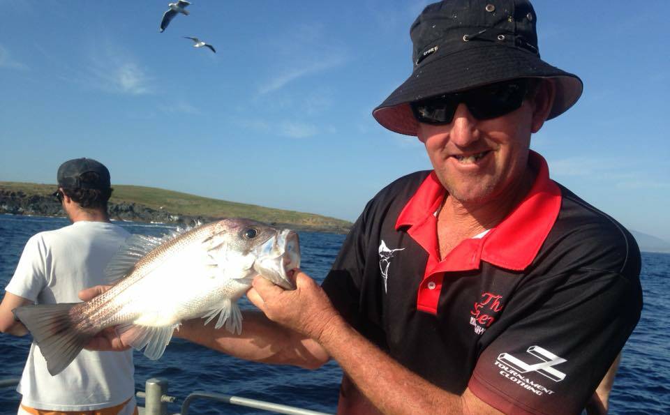 Skipper of The Sheriff charter boat Matt Betts and one of two very unusual pearl perch caught at Montague Island last week. Apparently they are great eating!