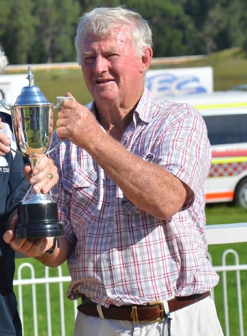 SADLY MISSED: The late trainer and veterinarian John Law collects the Moruya Cup for Bede Murray at Moruya on January 18.