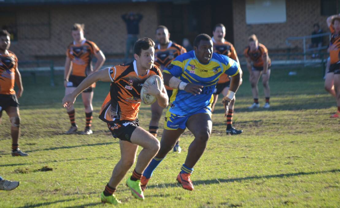 BREAKAWAY: Batemans Bay Tigers' player Tom Bollard on his way to scoring a try against Bombala. The two sides played out a thrilling 32 all draw in round eight of the group 16 competition.