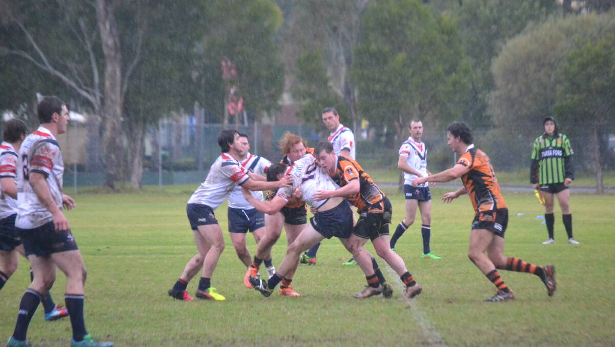 RAIN SOAKED: The Batemans Bay Tigers do battle with Bega at Mackay Park.