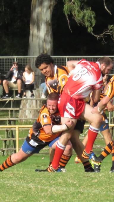 TIGER TACKLE:  Batemans Bay Tgers' players attempt to bring down a Devils player last week.