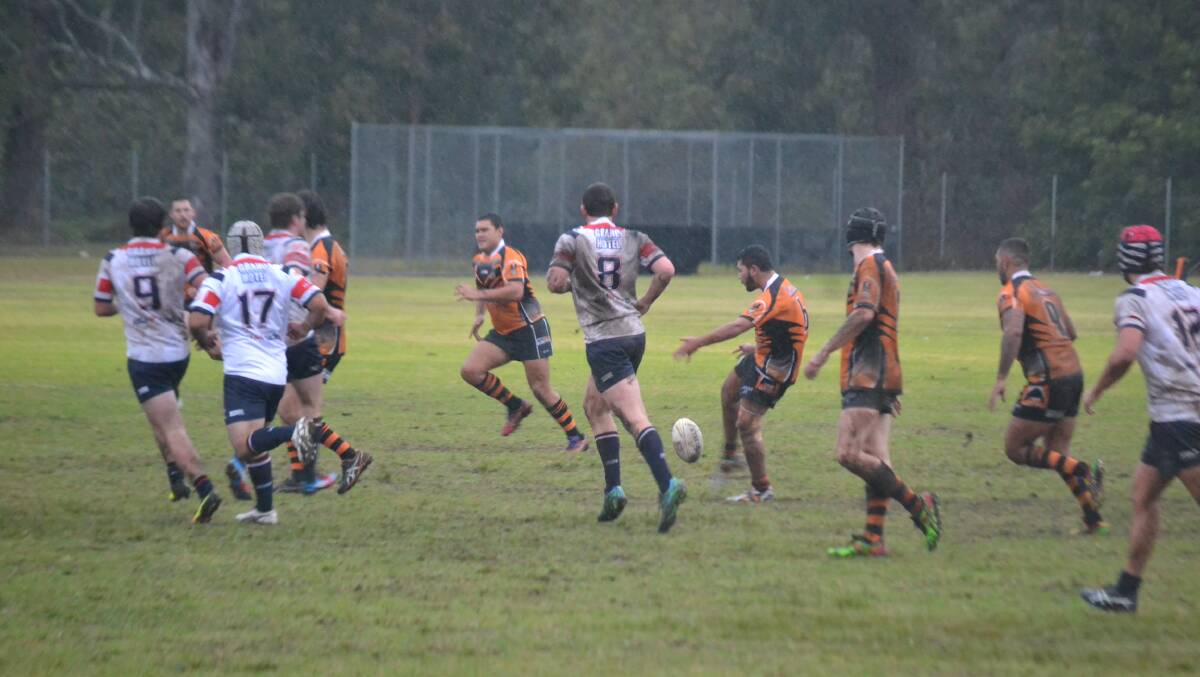 MUD MATCH: The Batemans Bay Tigers and Bega Roosters battle it out at Mackay Park on Sunday.