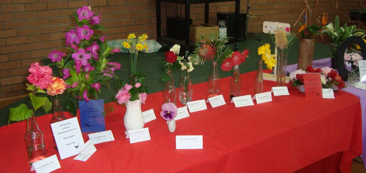 Technicolor table: Some of the beautiful blooms grown by Batemans Bay Garden Club members on display at their latest meeting. 