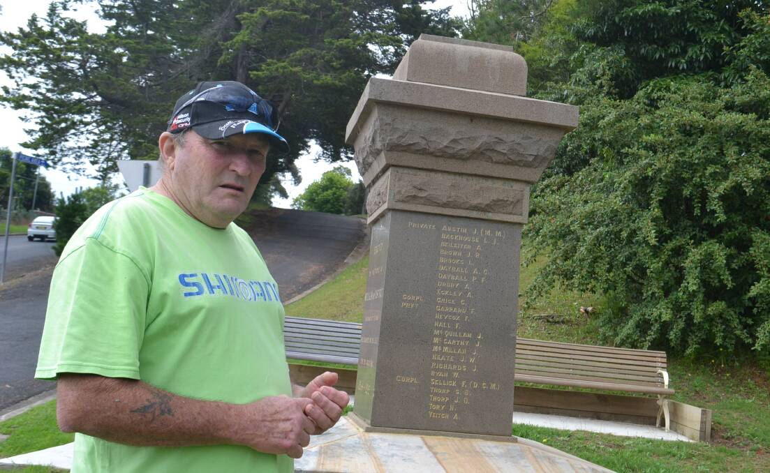 NOT GOOD: Paul Blanch inspects the recently vandalised Cenotaph in Nelligen. The statue is damaged in several places and will be difficult to restore to its former beauty. 