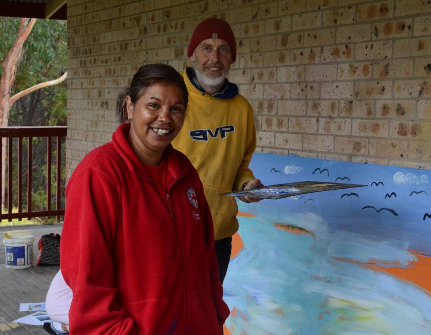 GIVING BACK: Cath Thomas and Robert Connel working on a mural for the new playground at the Wallaga Lake Koori village. Ms Thomas said she wants more opportunities for young people who want to live and work in the country.