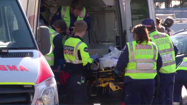 The boy is loaded into an ambulance to be taken to hospital. Photo: Top Notch Video
