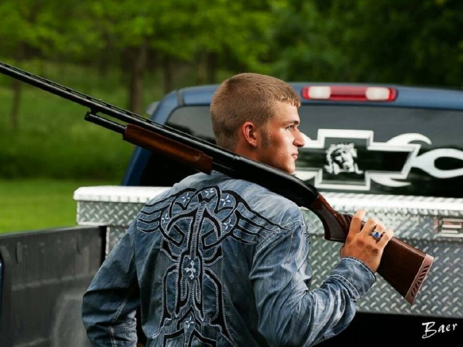 SCHOOL PORTRAIT: Dustin Langenberg of Bertrand, Nebraska, poses with a gun and a truck. Photo: Brian Baer Photography