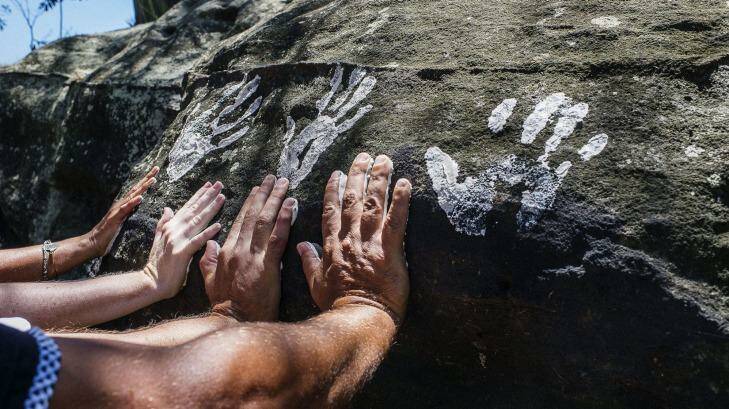 Hand prints are placed at Goat Island by local Aboriginal children. Photo: Christopher Pearce