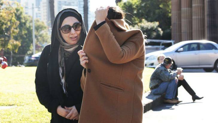 Mohammed Hamzy's wife Meltem Yarar (under the coat) with an unidentified woman outside court on Wednesday. Photo: Jessica Hromas