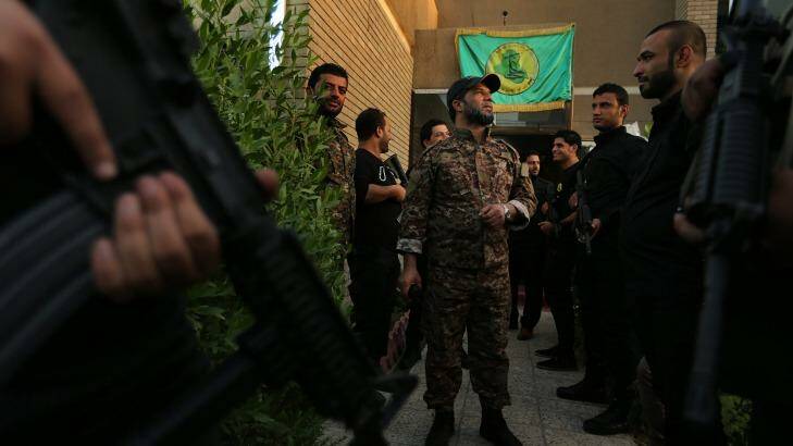Don't call them militias: Haji Jaafar al-Bindawi (centre) with his men at the Imam Ali Brigade's headquarters in Baghdad. Photo: Kate Geraghty