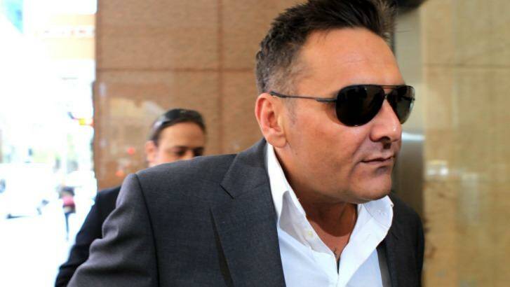 Dark glasses all round: George Alex arrives to give evidence at the royal commission on Friday.  Photo: James Alcock