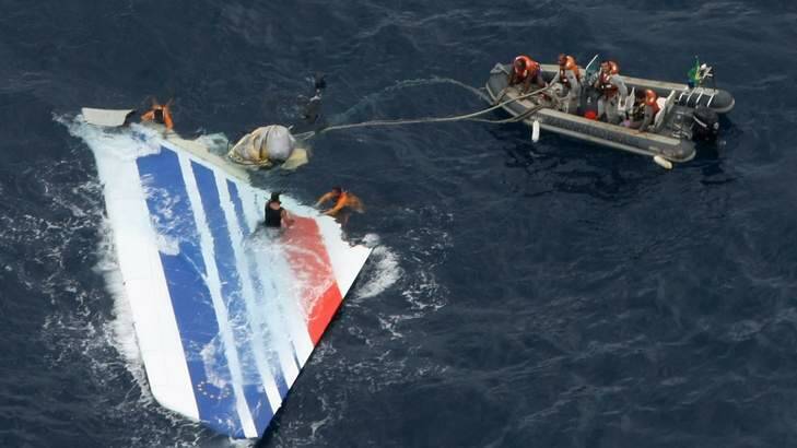 Sailors pick a piece of debris from Air France flight AF447 out of the Atlantic Ocean in 2009. It took two years to find the plane's black box. Photo: Supplied