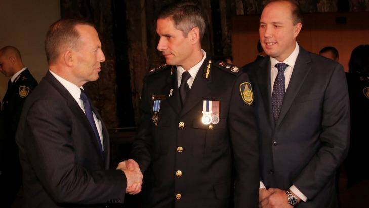 Prime Minister Tony Abbott at the swearing in ceremony of the inaugural Border Force Commissioner Roman Quaedvliegn with Immigration Minister Peter Dutton last month.  Photo: Andrew Meares