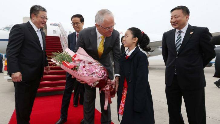 Prime Minister Malcolm Turnbull was presented with flowers on arrival in Shanghai. Photo: Andrew Meares