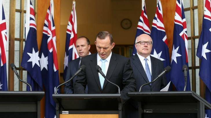 Prime Minister Tony Abbott with Immigration Minister Peter Dutton and Attorney-General George Brandis during a joint press conference at Parliament House on Tuesday.  Photo: Alex Ellinghausen