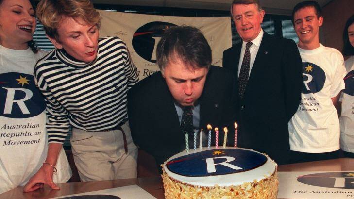 Malcolm Turnbull blows out the candles on a cake marking seven years of the ARM, flanked by Wendy Machin and Neville Wran. Photo: Robert Pearce