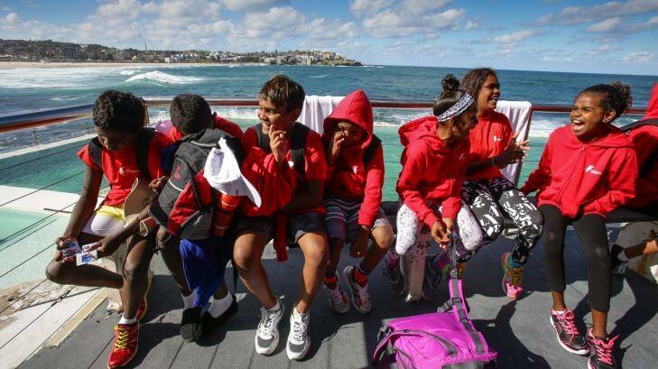 Rewards: Year 5 and 6 students warm up in the sun after their swim at Bondi Icebergs. Photo: Dallas Kilponen