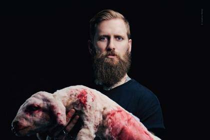 Jona Weinhofen and a prop designed to look like a lamb carcass in a campaign video for People for the Ethical Treatment of Animals. Photo: Supplied