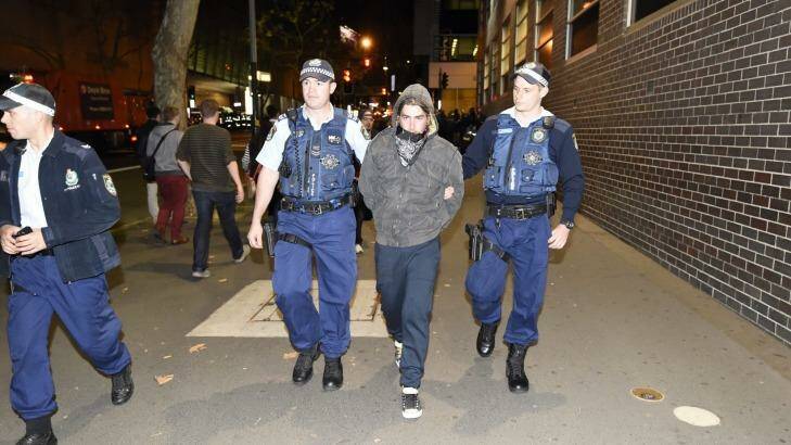 A man is arrested outside the ABC's headquarters in Ultimo on Monday night, in demonstrations for and against Pauline Hanson. Photo: Wolter Peeters