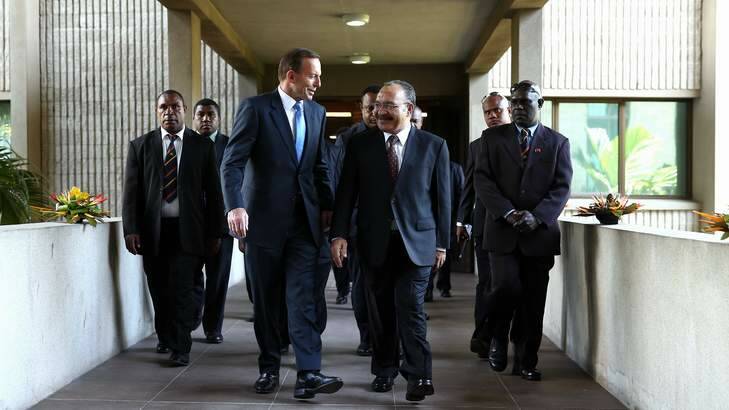 Prime Minister Tony Abbott and PNG Prime Minister Peter O'Neill walk towards a meeting, at Parliament House in Port Moresby on Friday. Photo: Alex Ellinghausen