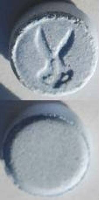 An "ecstasy" pill, with scissor stamp, similar to the one used by the four people hospitalised . Photo: NSW Police