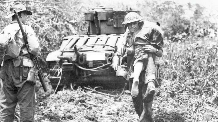 Australian troops moved in behind Matilda tanks for the dawn attack on the Japanese held village of Sattelberg in 1943 during the New Guinea campaign. Photo: AWM/Norman Brown