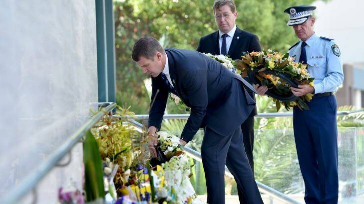 Mr Baird places a floral tribute for NSW Police accountant Curtis Cheng outside Parramatta Police Headquarters.
on Tuesday. Photo: Steven Siewert