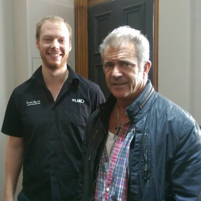 Brush with fame: The George Hotel barman Lochlainn Whitaker with Mel Gibson in Ballarat on Tuesday.