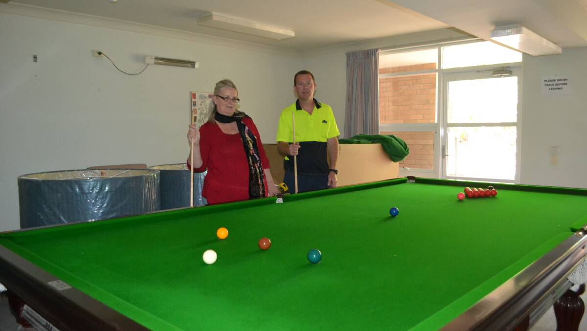 SPACE ISSUE: Edgewood Park facility manager Barbara Maranik and maintenance officer Andrew Craft with the full-sized English billiards table they are trying to find a home for.