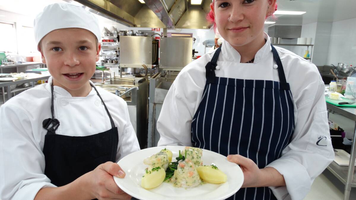 RECIPE FOR SUCCESS: Sam Lavender, left, may be of tender years, but he plans to carve up the cooking world. The 15-year-old is mixing school with his TAFE commercial cookery studies. He is pictured with Narooma student Cody Brown.
