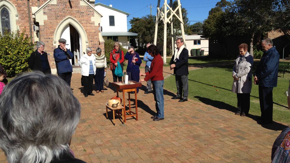 CLIMATE CONCERN: Moruya Anglican minister Reverend Linda Chapman during a ceremony next to the bell tower at the Moruya church, which will be one of the areas of focus at a climate change rally this Sunday.
