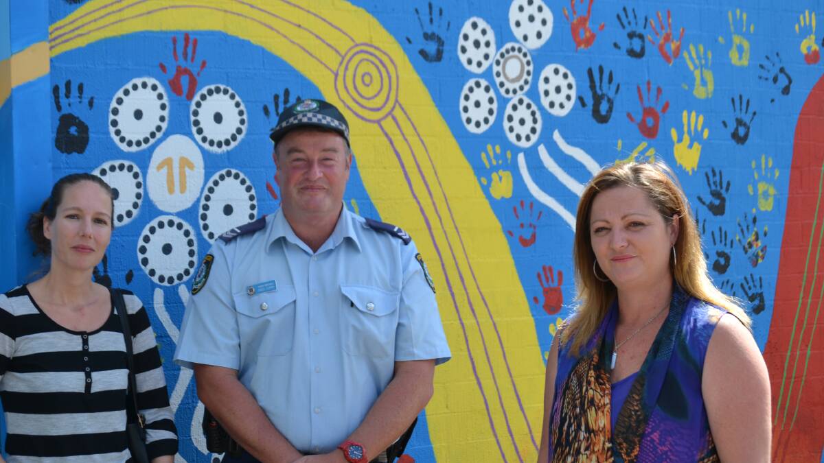 SAD END: Professionals working with teens regret the loss of Youth Connections. They include Juvenile Justice NSW’s Janet Bells, the PCYC’s Senior Constable Greg Curry and learning coach Debbie Grant. They are pictured at the Youth Connections mural in Batemans Bay.
