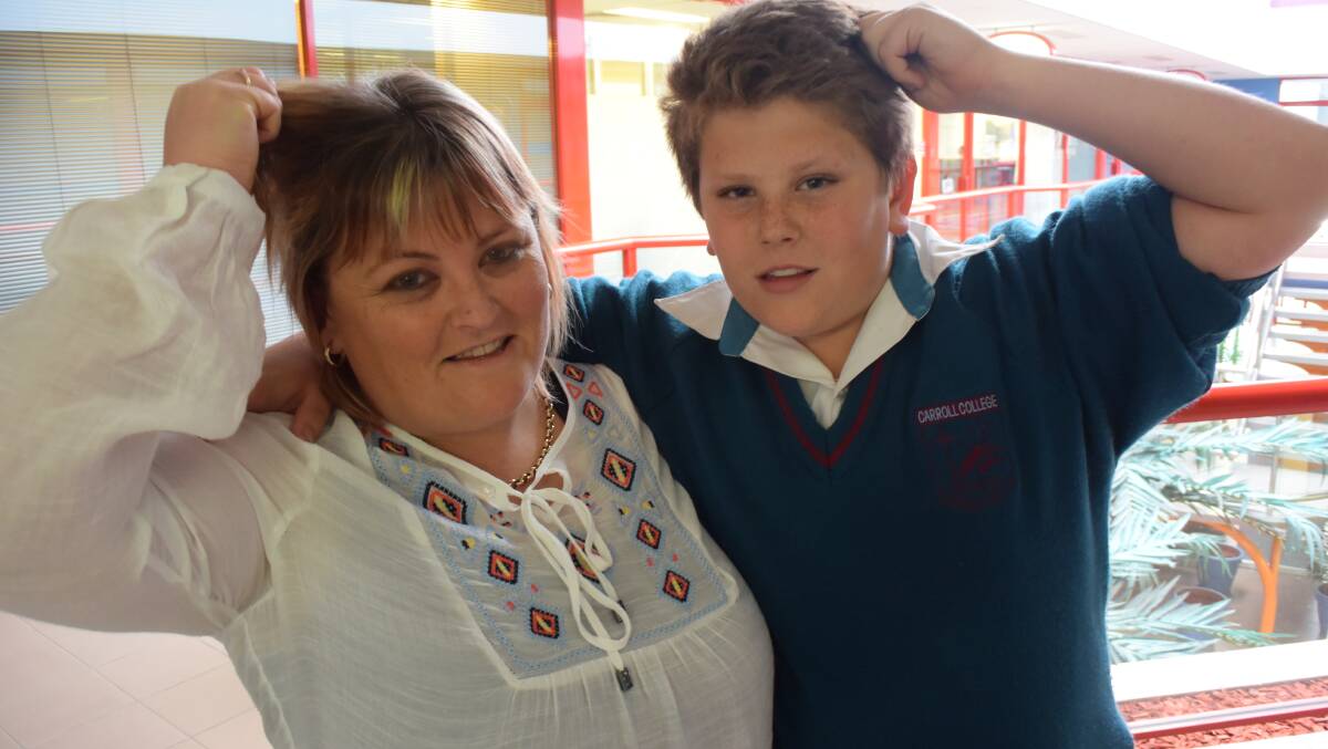 SHARED SHAVE: Batemans Bay mother and son Katrina and Jacob Collins with the hair they will lose to raise funds for the Moruya Oncology Unit in September.
