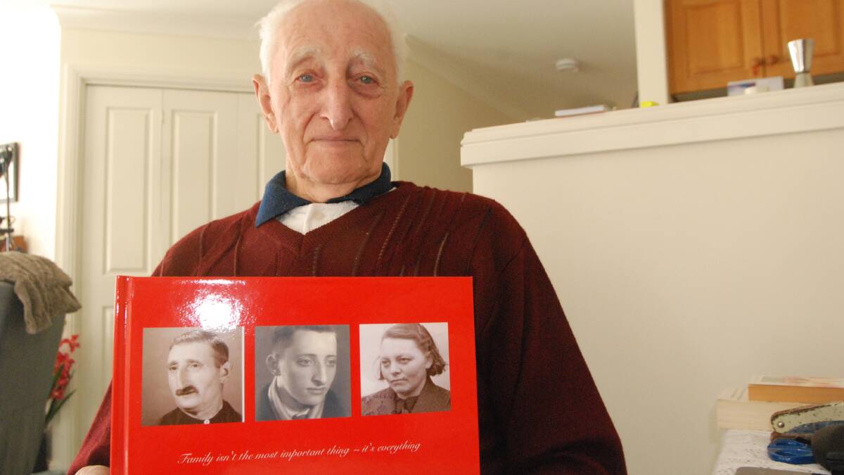 FAMILY MEMORIES: Dutch-born 90-year-old Gerrit De Haas of Batemans Bay with a photo of him with father Gerrit and mother Fena.