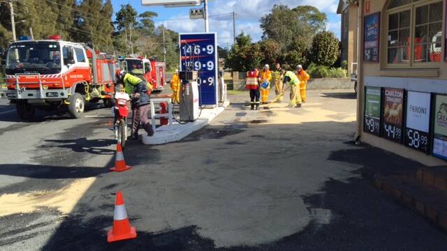 DIESEL SPILL: A Moruya Fire and Rescue and Rural Fire Service firefighters clean up a diesel spill at Broulee on Thursday.