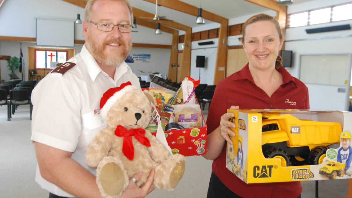 CRUNCHING CHRISTMAS: Batemans Bay Salvation Army Captains Ross and Melanie-Anne Holland with donated Christmas gifts.  
